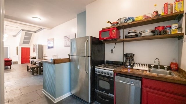 kitchen featuring appliances with stainless steel finishes, sink, and tile patterned flooring