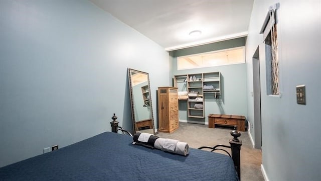 bedroom with lofted ceiling and carpet flooring