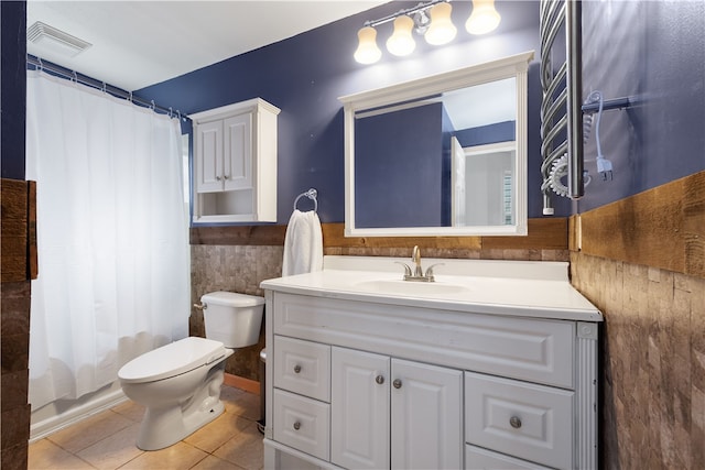 full bathroom featuring shower / bath combo, tile patterned floors, vanity, tile walls, and toilet