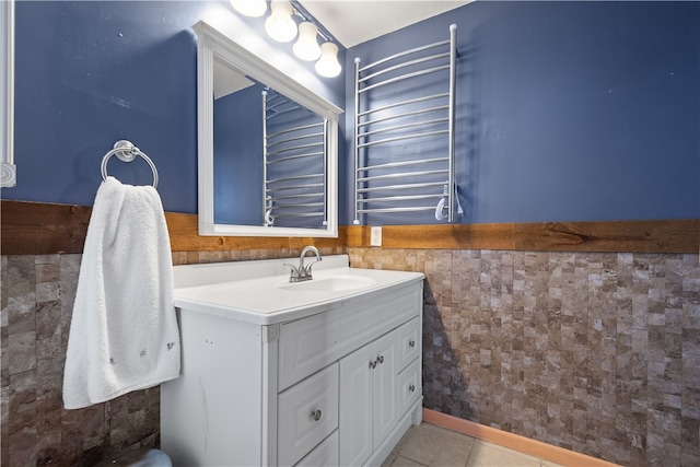 bathroom featuring tile patterned flooring, vanity, and radiator