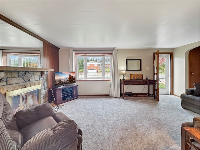 living room with a healthy amount of sunlight, carpet floors, and a fireplace