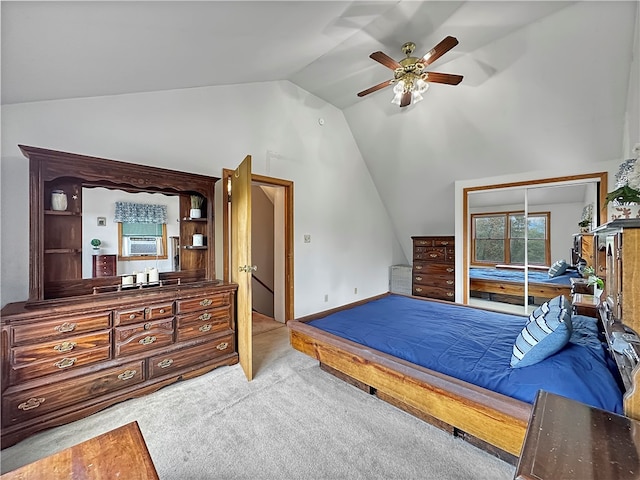 bedroom featuring ceiling fan, cooling unit, light colored carpet, vaulted ceiling, and a closet