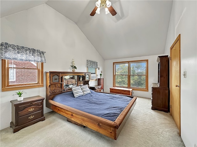 carpeted bedroom with ceiling fan and high vaulted ceiling