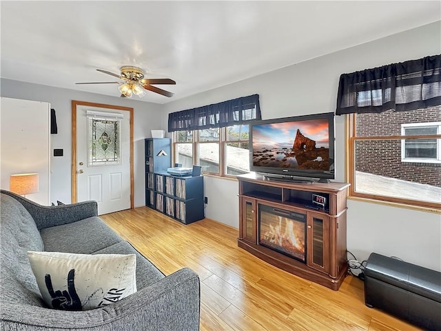 living room featuring wood-type flooring and ceiling fan