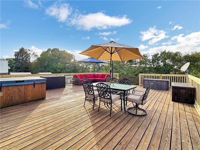 wooden deck with an outdoor hangout area and a hot tub