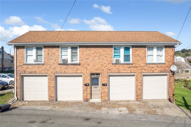 view of front of property with cooling unit and a garage