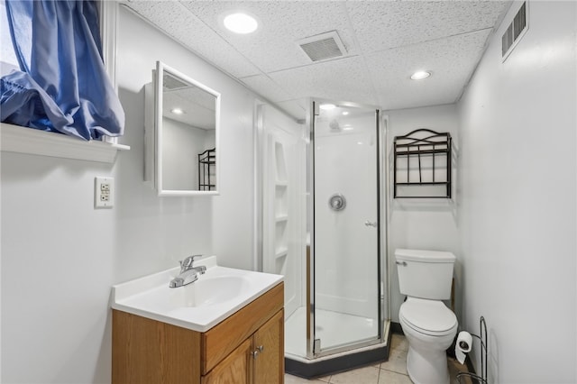 bathroom featuring tile patterned floors, vanity, toilet, and walk in shower