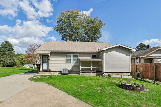 exterior space with a lawn and central air condition unit