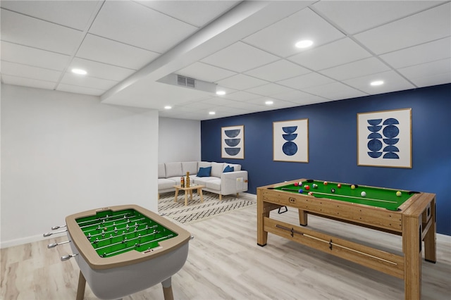 game room featuring hardwood / wood-style floors and a drop ceiling