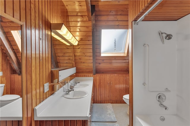 full bathroom with shower / bathing tub combination, toilet, a skylight, vanity, and wooden walls