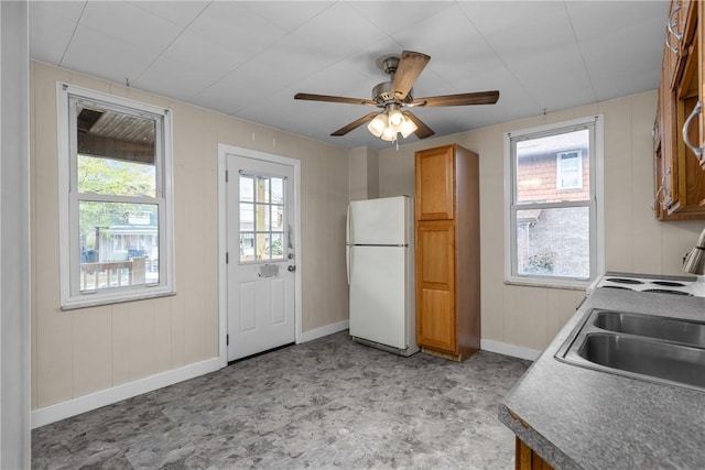 kitchen with ceiling fan, white refrigerator, and sink