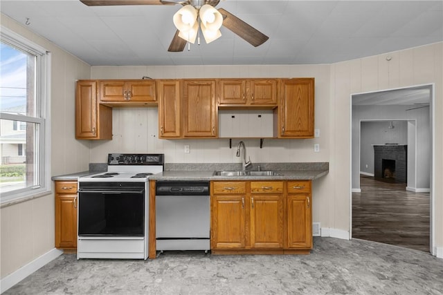 kitchen with sink, stainless steel dishwasher, plenty of natural light, and white electric range