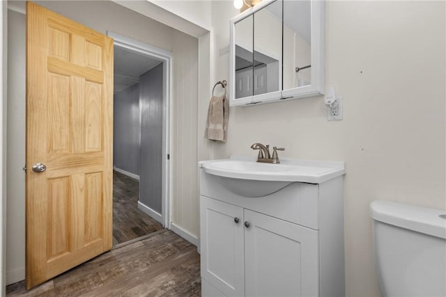 bathroom featuring hardwood / wood-style floors, vanity, and toilet