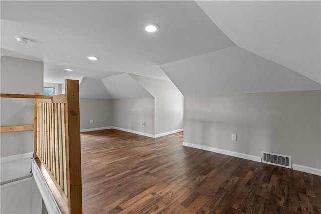 additional living space featuring dark hardwood / wood-style floors and lofted ceiling