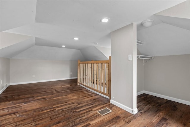 bonus room with lofted ceiling and dark wood-type flooring