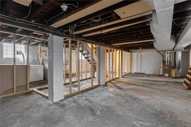 basement with heating unit and washer and clothes dryer