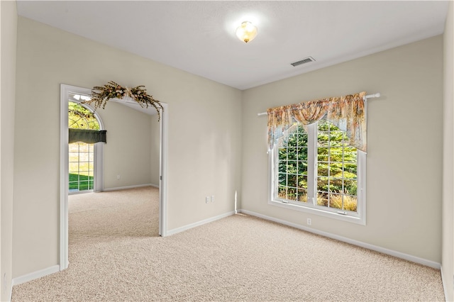 unfurnished room featuring light colored carpet