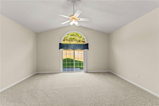 carpeted empty room featuring ceiling fan and vaulted ceiling