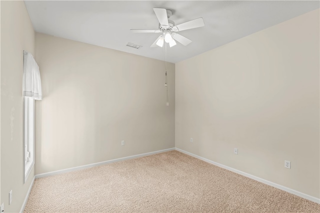 empty room featuring light colored carpet and ceiling fan