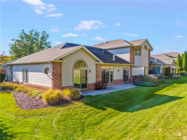 back of property featuring a patio and a lawn