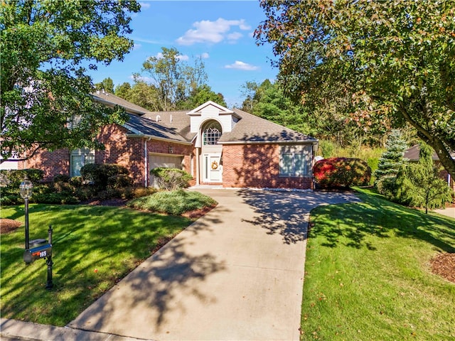 view of front of home with a front yard and a garage