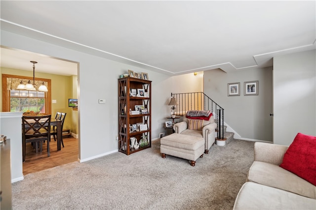 living room with a chandelier and carpet flooring