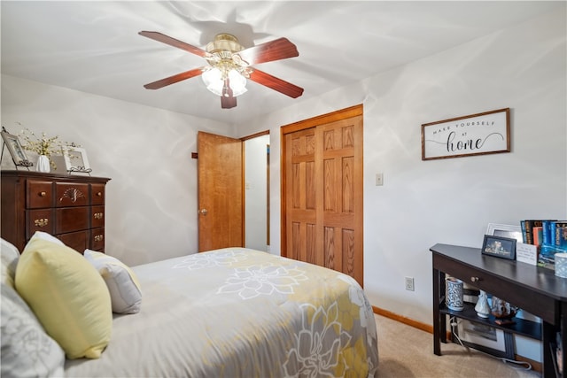 bedroom with light colored carpet and ceiling fan