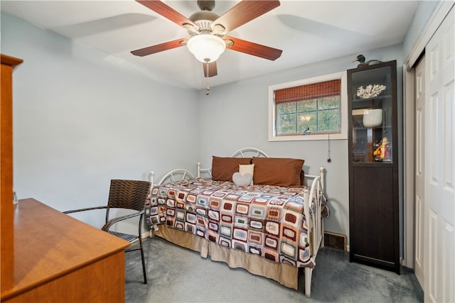 carpeted bedroom featuring a closet and ceiling fan