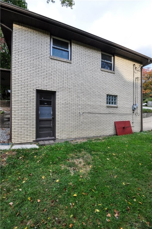 back of house with a lawn