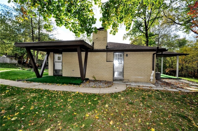 rear view of house with a yard