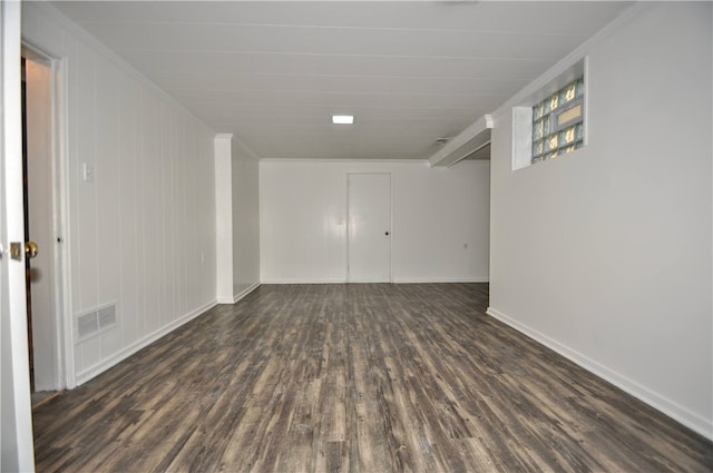 spare room featuring ornamental molding and dark hardwood / wood-style floors