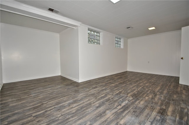 spare room featuring crown molding and dark hardwood / wood-style floors