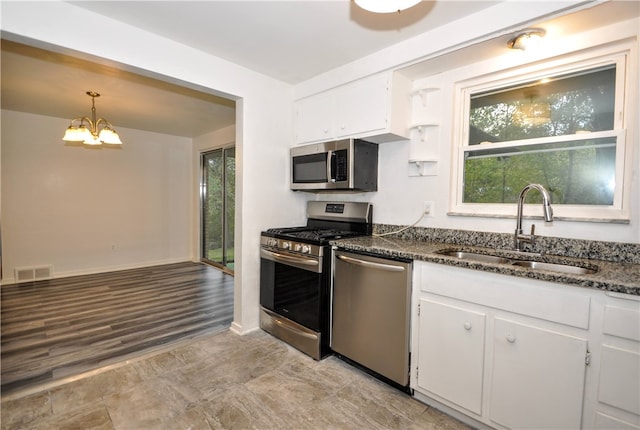 kitchen with a healthy amount of sunlight, sink, appliances with stainless steel finishes, and white cabinets