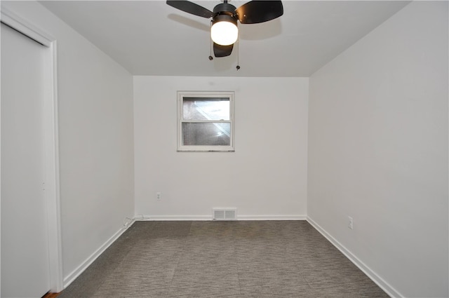 carpeted empty room featuring ceiling fan