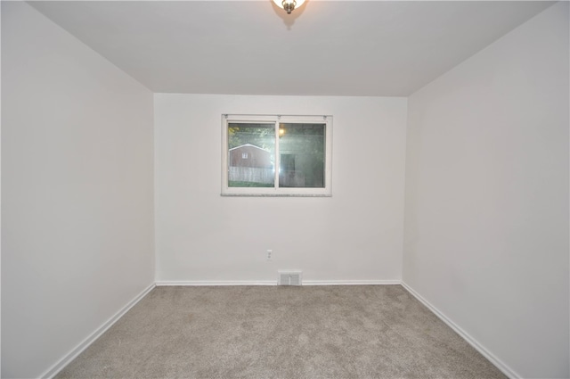 spare room with light carpet