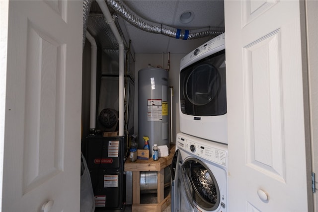 laundry area featuring water heater and stacked washing maching and dryer