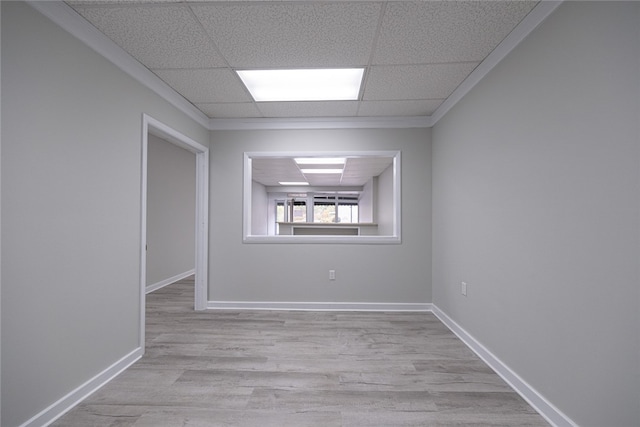 unfurnished room with light hardwood / wood-style floors and a paneled ceiling