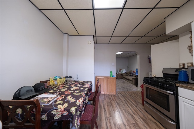 dining space featuring a paneled ceiling and wood-type flooring