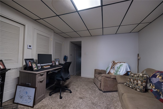 carpeted office space with a drop ceiling