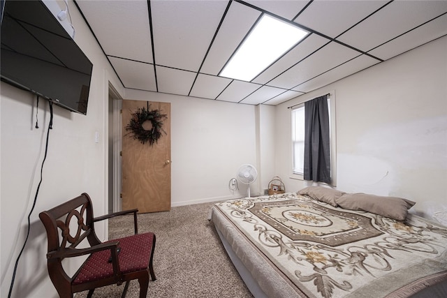 bedroom featuring carpet and a paneled ceiling