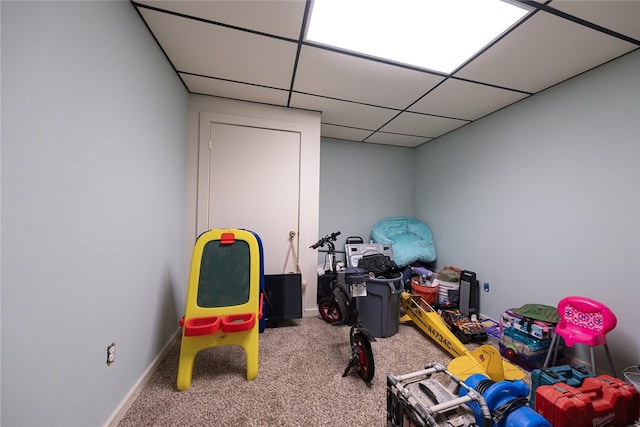 playroom featuring carpet and a drop ceiling