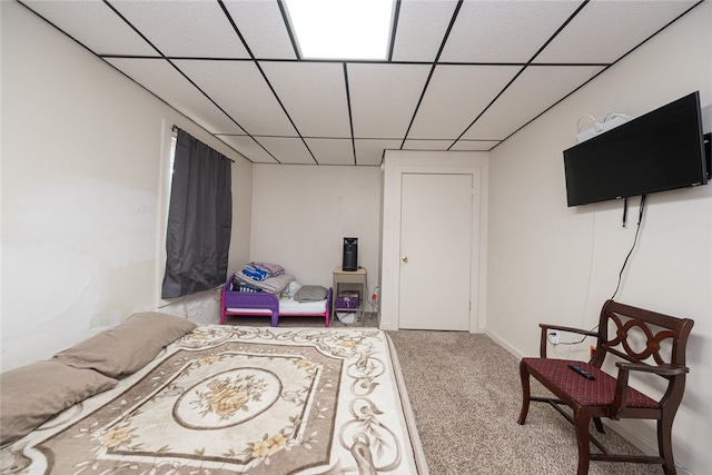 sitting room featuring light carpet and a drop ceiling