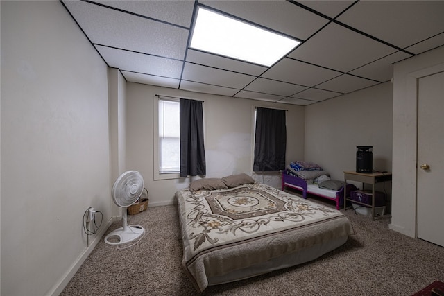 bedroom featuring a paneled ceiling and carpet flooring