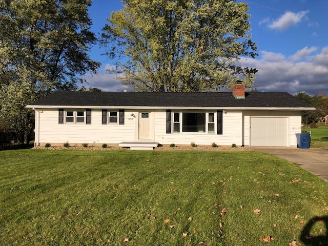 single story home featuring a garage and a front lawn