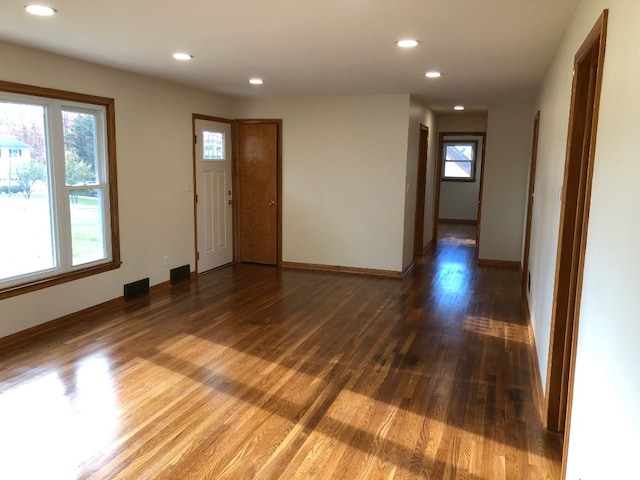 interior space with a healthy amount of sunlight and dark hardwood / wood-style flooring