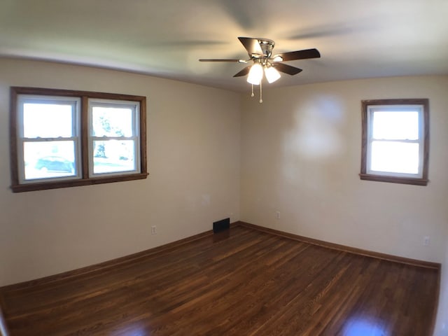 empty room featuring ceiling fan and dark hardwood / wood-style flooring