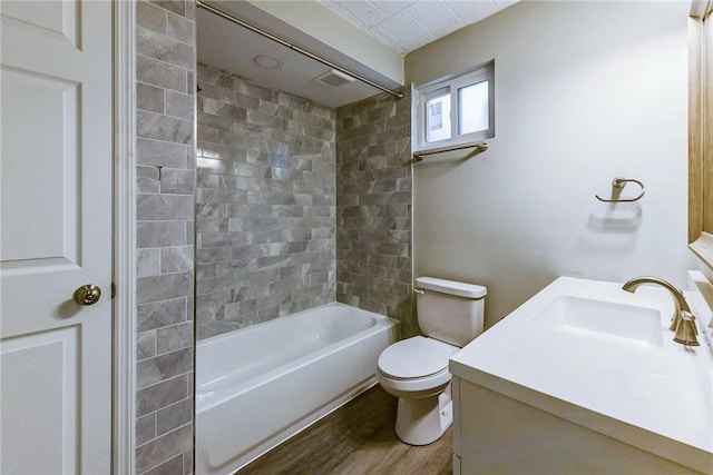 full bath with vanity, toilet, visible vents, tub / shower combination, and wood finished floors