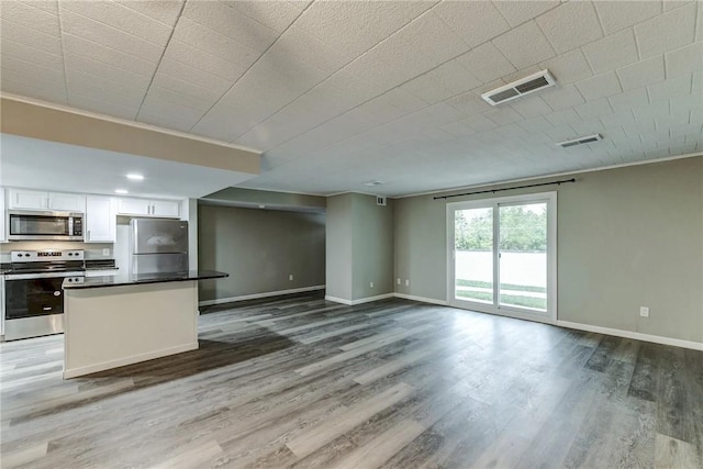 kitchen featuring white cabinets, visible vents, dark countertops, and appliances with stainless steel finishes
