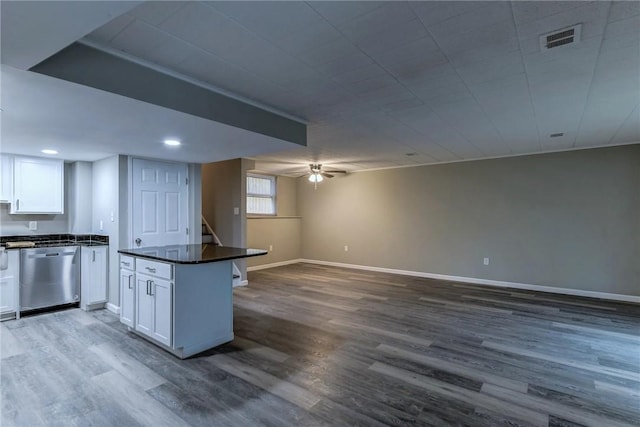 kitchen with visible vents, dark countertops, dishwasher, white cabinets, and open floor plan