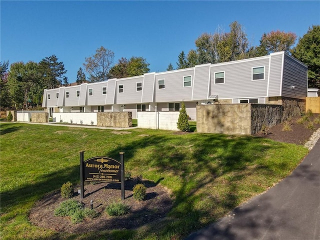 back of property featuring a lawn